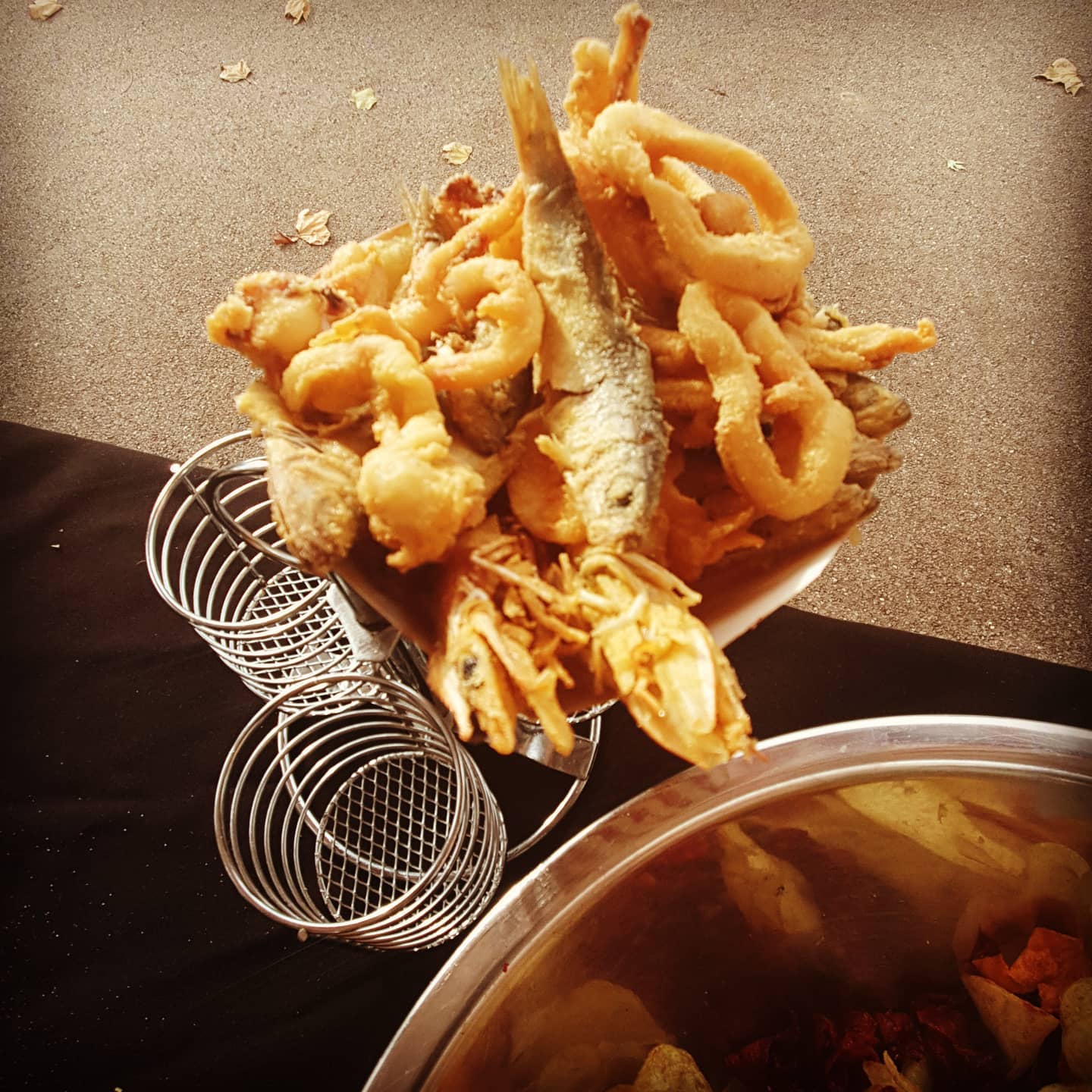 Golden fritto misto in a fryer basket